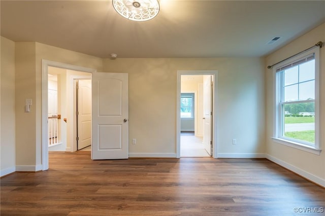 207 Eliza Ln, Aylett, VA 23009 - unfurnished bedroom with multiple windows, baseboards, and wood finished floors
