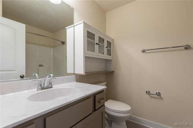 207 Eliza Ln, Aylett, VA 23009 - bathroom with toilet, vanity, baseboards, and a shower