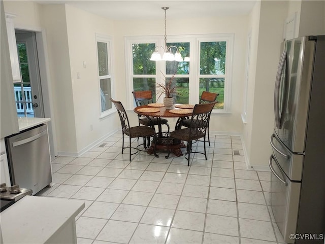 1412 Pritchard Ter, Chesterfield, VA 23235 - dining area featuring a chandelier, healthy amount of natural light, light tile patterned floors, and baseboards