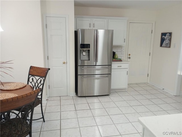 1412 Pritchard Ter, Chesterfield, VA 23235 - kitchen with stainless steel fridge with ice dispenser, white cabinetry, light countertops, light tile patterned floors, and baseboards