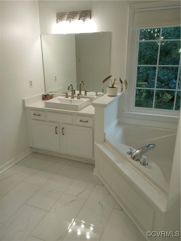 1412 Pritchard Ter, Chesterfield, VA 23235 - full bathroom with marble look tiles, vanity, a bath, and baseboards