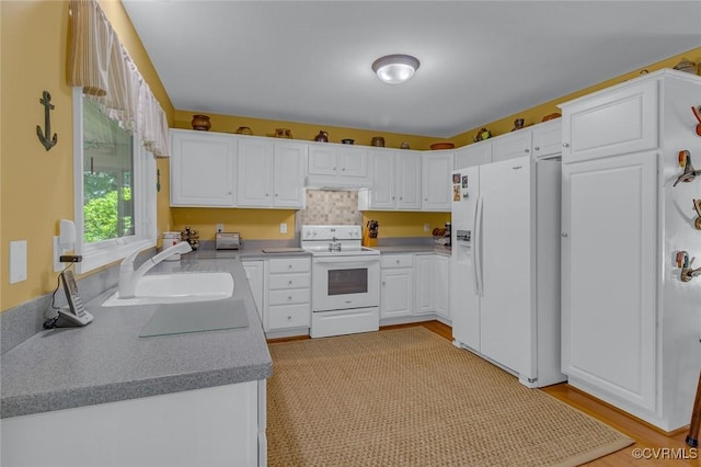 431 Ships Row, Montross, VA 22520 - kitchen featuring white appliances, white cabinets, light countertops, and light wood-style flooring