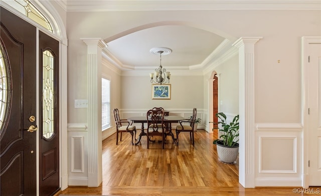 2220 French Hill Ter, Powhatan, VA 23139 - entrance foyer with arched walkways, ornate columns, a chandelier, light wood-style flooring, and crown molding