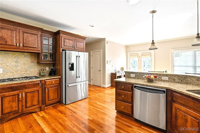 2220 French Hill Ter, Powhatan, VA 23139 - kitchen with stainless steel appliances, light wood finished floors, glass insert cabinets, decorative backsplash, and crown molding