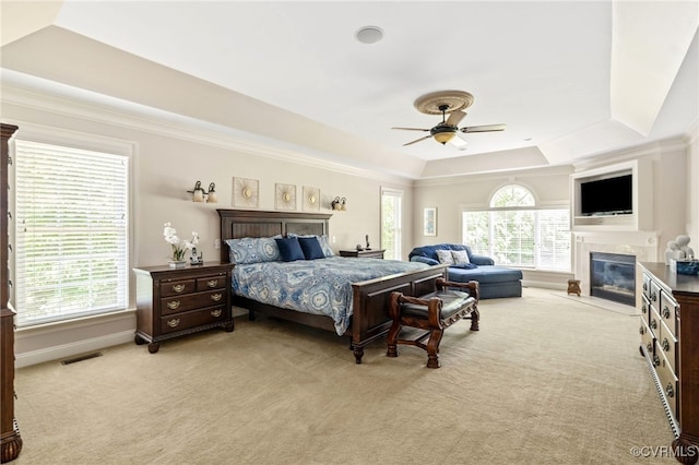 2220 French Hill Ter, Powhatan, VA 23139 - bedroom with a tray ceiling, light carpet, a tiled fireplace, baseboards, and crown molding