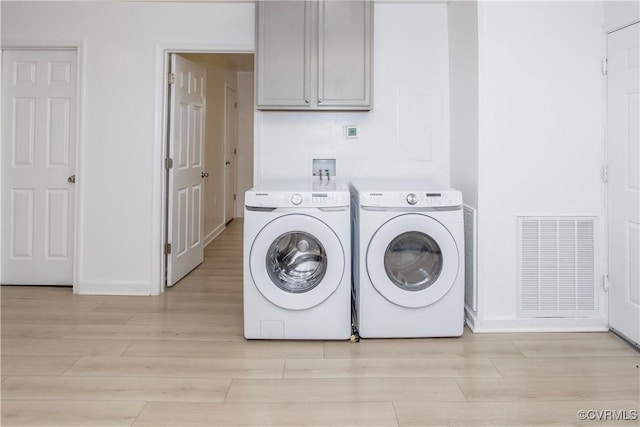 321 Porterville St, Petersburg, VA 23803 - washroom with light wood-type flooring, separate washer and dryer, cabinet space, and baseboards