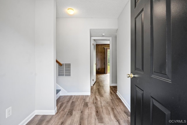 9548 Bent Wood Ln, North Chesterfield, VA 23237 - hall with wood finished floors, baseboards, a textured ceiling, and stairs