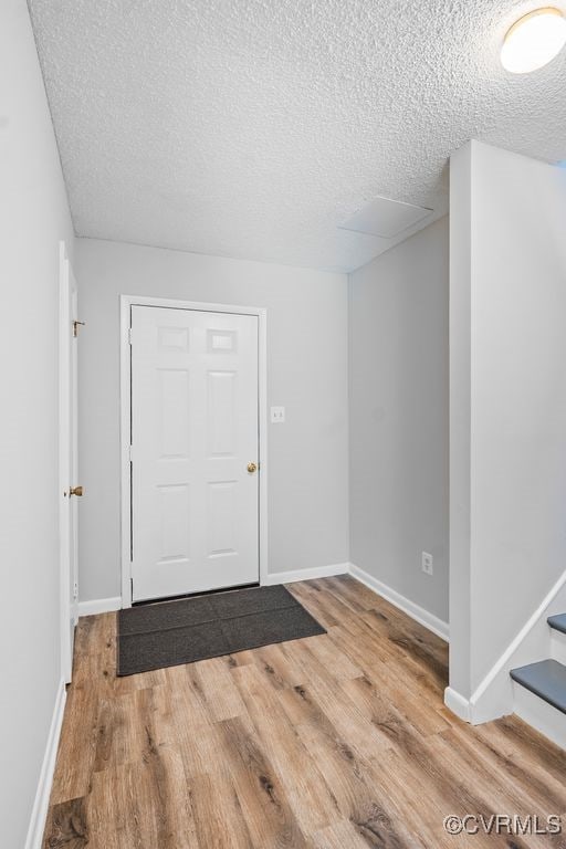 9548 Bent Wood Ln, North Chesterfield, VA 23237 - foyer entrance featuring a textured ceiling, wood finished floors, stairs, and baseboards