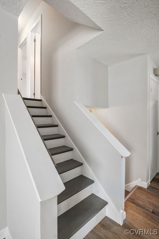 9548 Bent Wood Ln, North Chesterfield, VA 23237 - stairs featuring a textured ceiling, wood finished floors, and baseboards