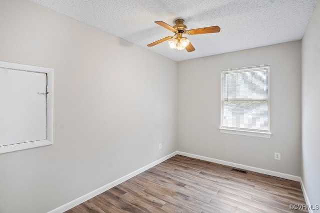 9548 Bent Wood Ln, North Chesterfield, VA 23237 - spare room with wood finished floors, a ceiling fan, baseboards, and a textured ceiling