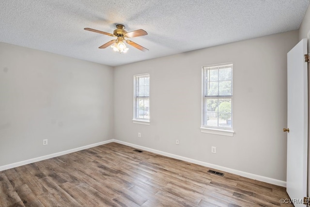 9548 Bent Wood Ln, North Chesterfield, VA 23237 - unfurnished room featuring plenty of natural light, a ceiling fan, wood finished floors, baseboards, and a textured ceiling