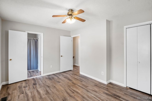9548 Bent Wood Ln, North Chesterfield, VA 23237 - unfurnished bedroom featuring wood finished floors, baseboards, a textured ceiling, a closet, and ceiling fan