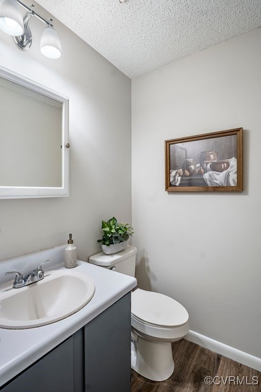9548 Bent Wood Ln, North Chesterfield, VA 23237 - bathroom featuring vanity, wood finished floors, and a textured ceiling