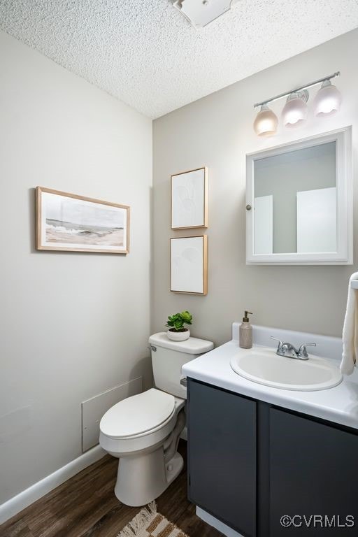 9548 Bent Wood Ln, North Chesterfield, VA 23237 - bathroom with wood finished floors, vanity, and a textured ceiling