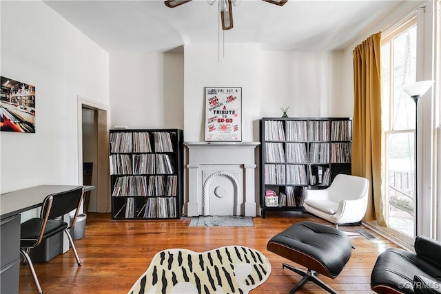 430 S Pine St, Richmond, VA 23220 - sitting room with healthy amount of natural light, a ceiling fan, a fireplace with flush hearth, and wood finished floors