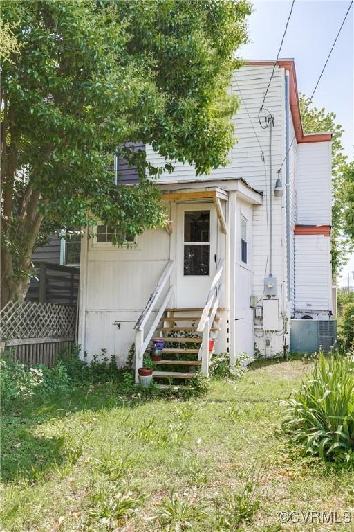 430 S Pine St, Richmond, VA 23220 - rear view of house featuring central AC unit, entry steps, and a yard