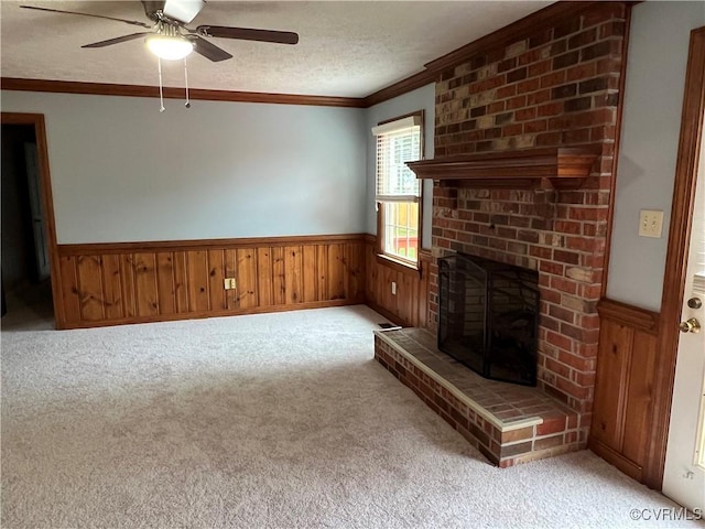 8172 Dunfee Ln, Mechanicsville, VA 23111 - unfurnished living room with crown molding, light carpet, a ceiling fan, a wainscoted wall, and a fireplace