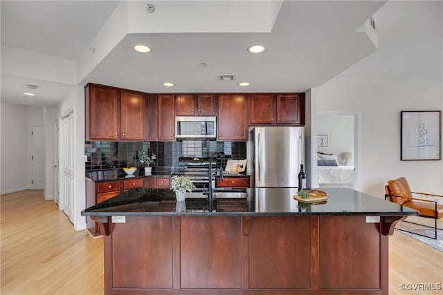 1101 Haxall Pt Unit U1001, Richmond, VA 23219 - kitchen featuring appliances with stainless steel finishes, light wood finished floors, a sink, backsplash, and recessed lighting