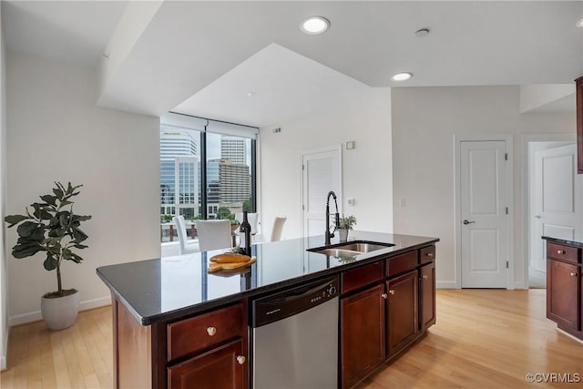 1101 Haxall Pt Unit U1001, Richmond, VA 23219 - kitchen with stainless steel dishwasher, a sink, light wood-style floors, dark brown cabinets, and a center island with sink