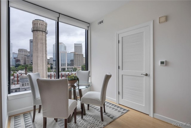 1101 Haxall Pt Unit U1001, Richmond, VA 23219 - dining room with expansive windows, baseboards, a city view, and light wood finished floors