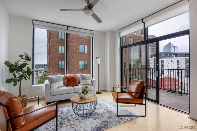 1101 Haxall Pt Unit U1001, Richmond, VA 23219 - sitting room featuring expansive windows, wood finished floors, ceiling fan, and a city view