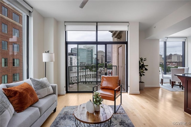 1101 Haxall Pt Unit U1001, Richmond, VA 23219 - living room featuring a city view, light wood-type flooring, and baseboards