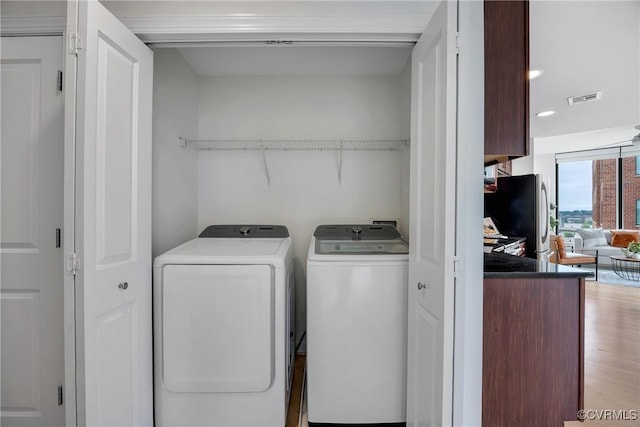 1101 Haxall Pt Unit U1001, Richmond, VA 23219 - laundry area with washer and dryer, light wood finished floors, and recessed lighting