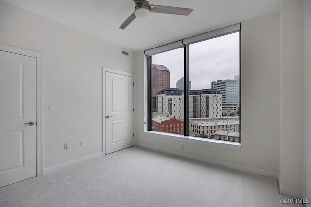 1101 Haxall Pt Unit U1001, Richmond, VA 23219 - empty room with carpet flooring, a ceiling fan, and a view of city