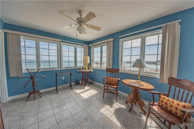 154 Riverside Dr, Deltaville, VA 23043 - living area with tile patterned floors, baseboards, and a ceiling fan