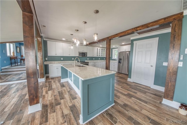 154 Riverside Dr, Deltaville, VA 23043 - kitchen with stainless steel appliances, white cabinets, dark wood-type flooring, a large island with sink, and recessed lighting
