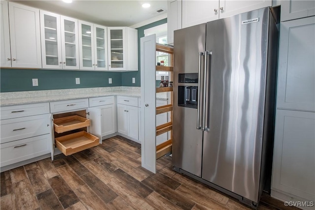 154 Riverside Dr, Deltaville, VA 23043 - kitchen featuring high quality fridge, dark wood-style floors, white cabinetry, and glass insert cabinets