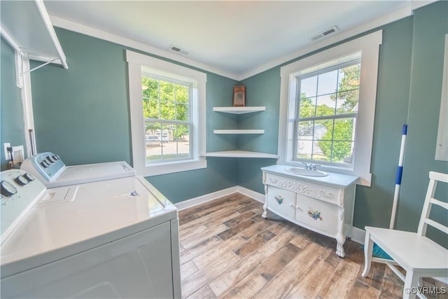 154 Riverside Dr, Deltaville, VA 23043 - laundry room featuring washer and clothes dryer, wood finished floors, and baseboards