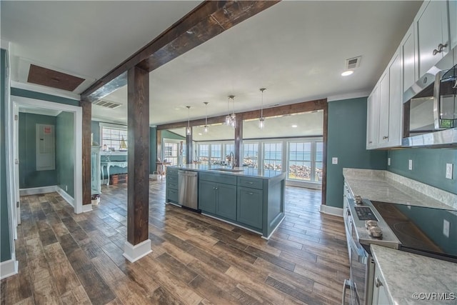 154 Riverside Dr, Deltaville, VA 23043 - kitchen with stainless steel appliances, a sink, baseboards, dark wood-style floors, and white cabinetry
