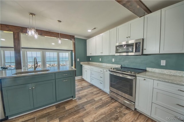 154 Riverside Dr, Deltaville, VA 23043 - kitchen with stainless steel appliances, a sink, dark wood-type flooring, white cabinetry, and beam ceiling