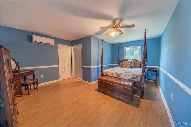 154 Riverside Dr, Deltaville, VA 23043 - bedroom with a wall unit AC, wood finished floors, baseboards, and ceiling fan