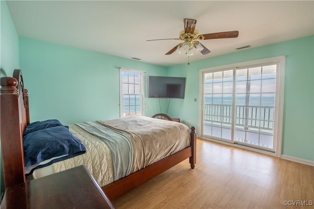 154 Riverside Dr, Deltaville, VA 23043 - bedroom featuring access to exterior, wood finished floors, ceiling fan, and baseboards