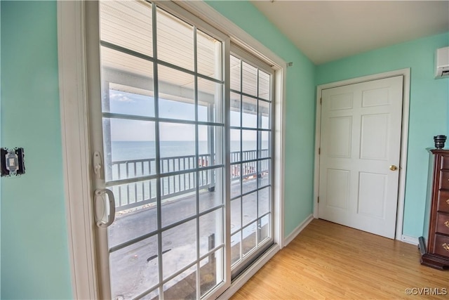 154 Riverside Dr, Deltaville, VA 23043 - doorway featuring a water view, light wood-style floors, baseboards, and plenty of natural light