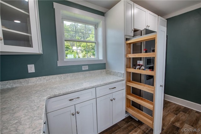 154 Riverside Dr, Deltaville, VA 23043 - kitchen featuring white cabinetry, dark wood finished floors, glass insert cabinets, and light stone countertops