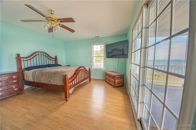 154 Riverside Dr, Deltaville, VA 23043 - bedroom with wood finished floors, baseboards, and a ceiling fan