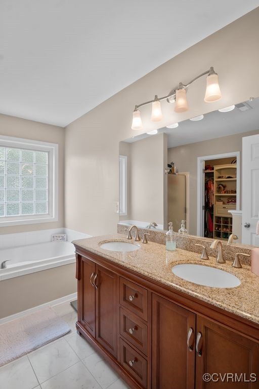 14825 Windjammer Dr, Midlothian, VA 23112 - full bath with double vanity, a walk in closet, a bath, tile patterned flooring, and a shower with shower door