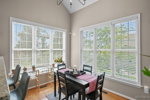14825 Windjammer Dr, Midlothian, VA 23112 - dining room with healthy amount of natural light, light wood-style flooring, and high vaulted ceiling