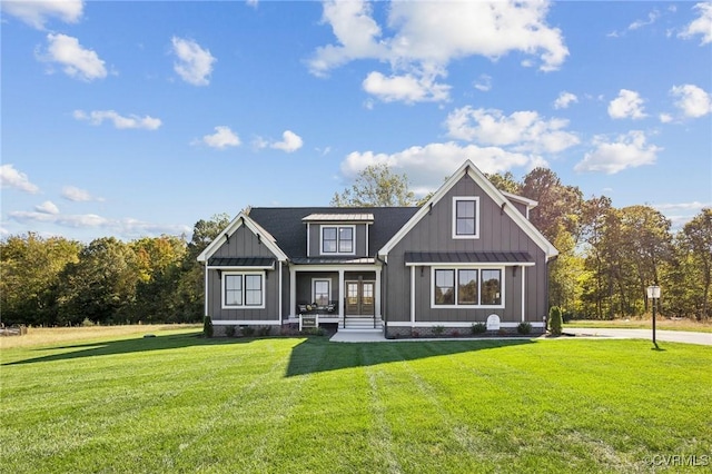 9463 Angels Share Dr, New Kent, VA 23124 - modern inspired farmhouse with a front lawn, board and batten siding, and french doors
