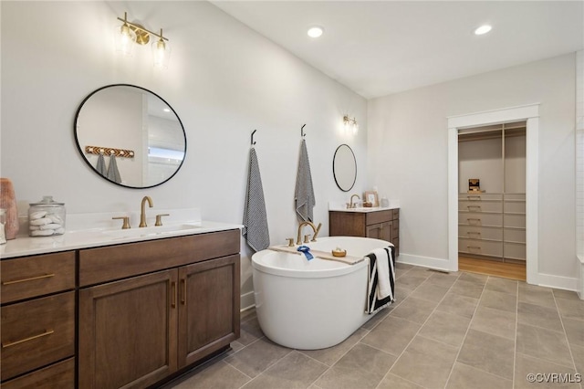 9463 Angels Share Dr, New Kent, VA 23124 - full bath featuring two vanities, a freestanding tub, tile patterned floors, baseboards, and recessed lighting