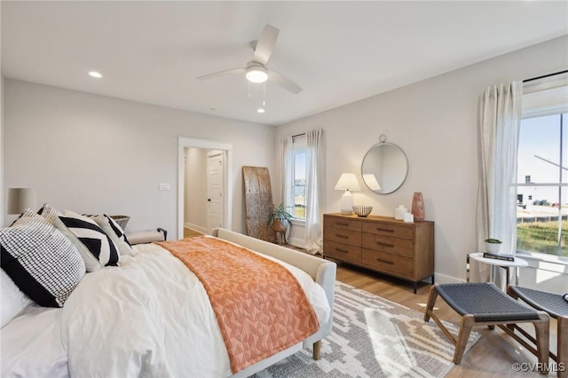 9463 Angels Share Dr, New Kent, VA 23124 - bedroom with multiple windows, light wood-style floors, a ceiling fan, and recessed lighting