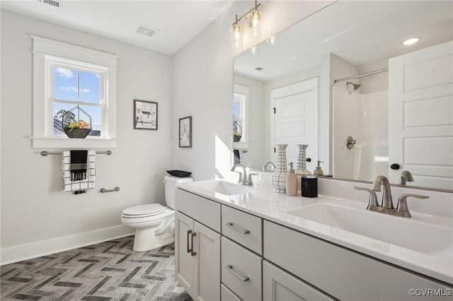 9463 Angels Share Dr, New Kent, VA 23124 - bathroom with baseboards, toilet, double vanity, and a shower