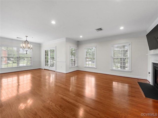 5241 Monument Ave Unit 2A, Henrico, VA 23226 - unfurnished living room featuring a fireplace with flush hearth, healthy amount of natural light, wood finished floors, a chandelier, and recessed lighting