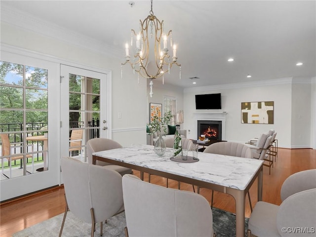 5241 Monument Ave Unit 2A, Henrico, VA 23226 - dining room with wood finished floors, a lit fireplace, recessed lighting, crown molding, and a chandelier