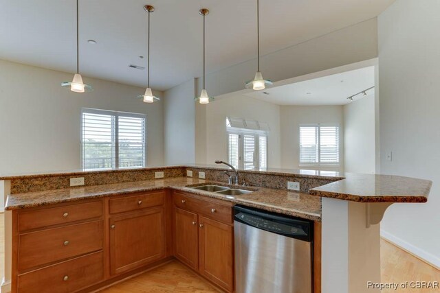 670 Town Center Dr Unit 418, Newport News, VA 23606 - kitchen with dishwasher, a sink, light wood finished floors, brown cabinets, and dark stone counters