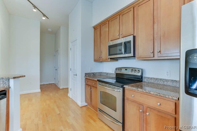 670 Town Center Dr Unit 418, Newport News, VA 23606 - kitchen featuring stainless steel appliances, light wood-type flooring, track lighting, and light stone countertops
