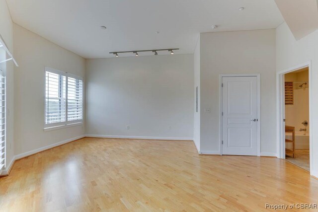 670 Town Center Dr Unit 418, Newport News, VA 23606 - empty room featuring rail lighting, light wood-style floors, and baseboards